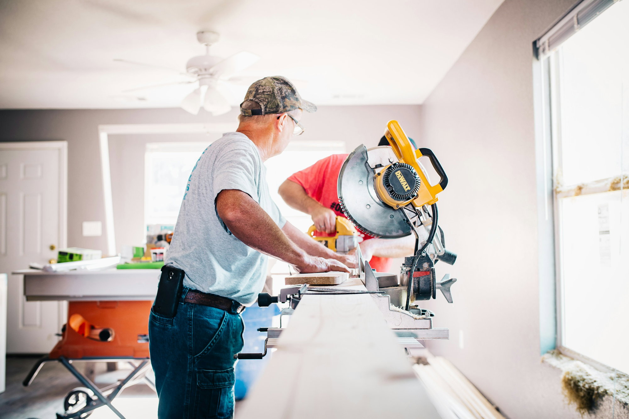 man-standing-infront-of-miter-saw.jpg man standing infront of miter saw